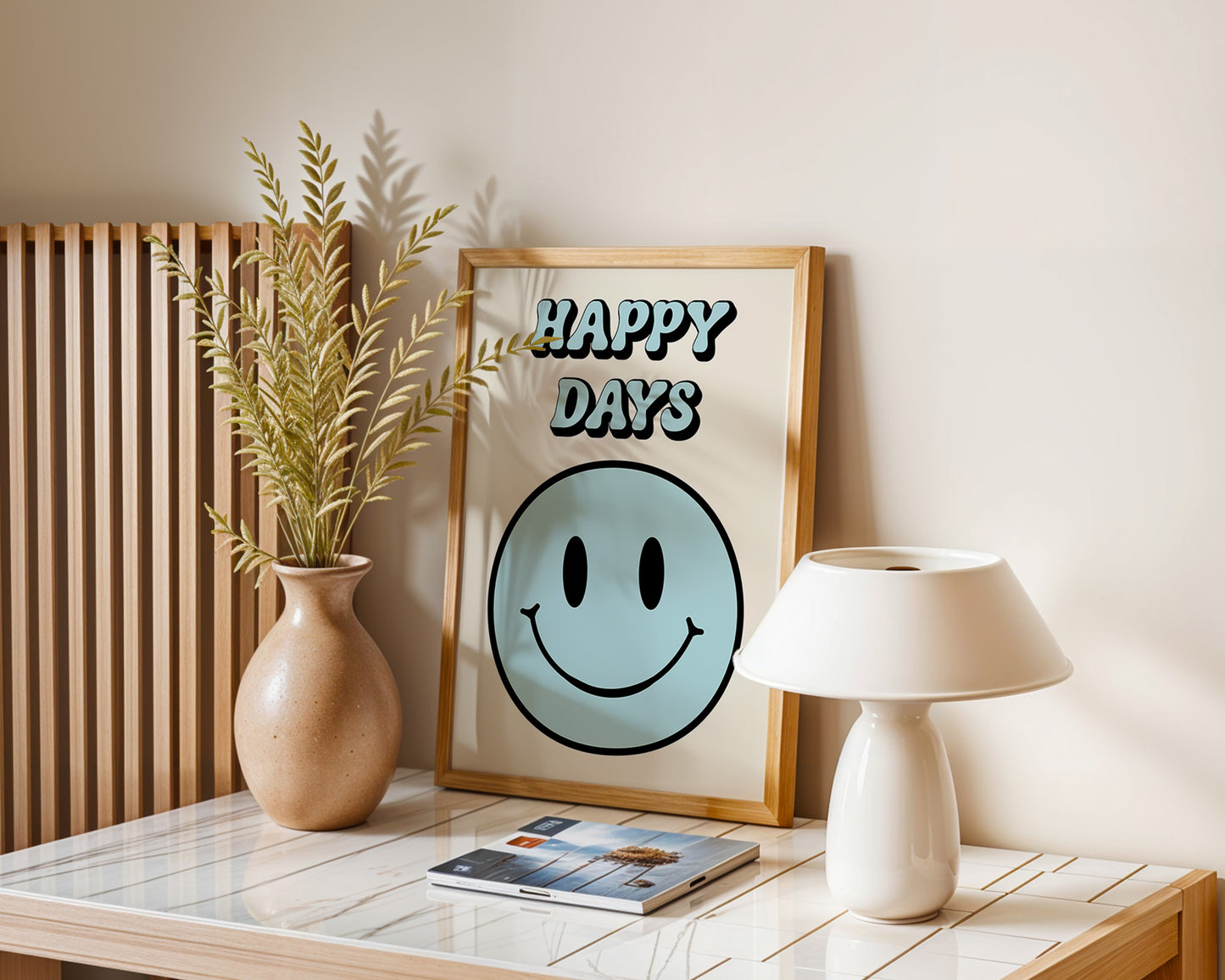 A series of 'Happy Days' retro art prints with various colored smiley faces displayed on a wall, below a window with natural light coming in and a plant to the side.