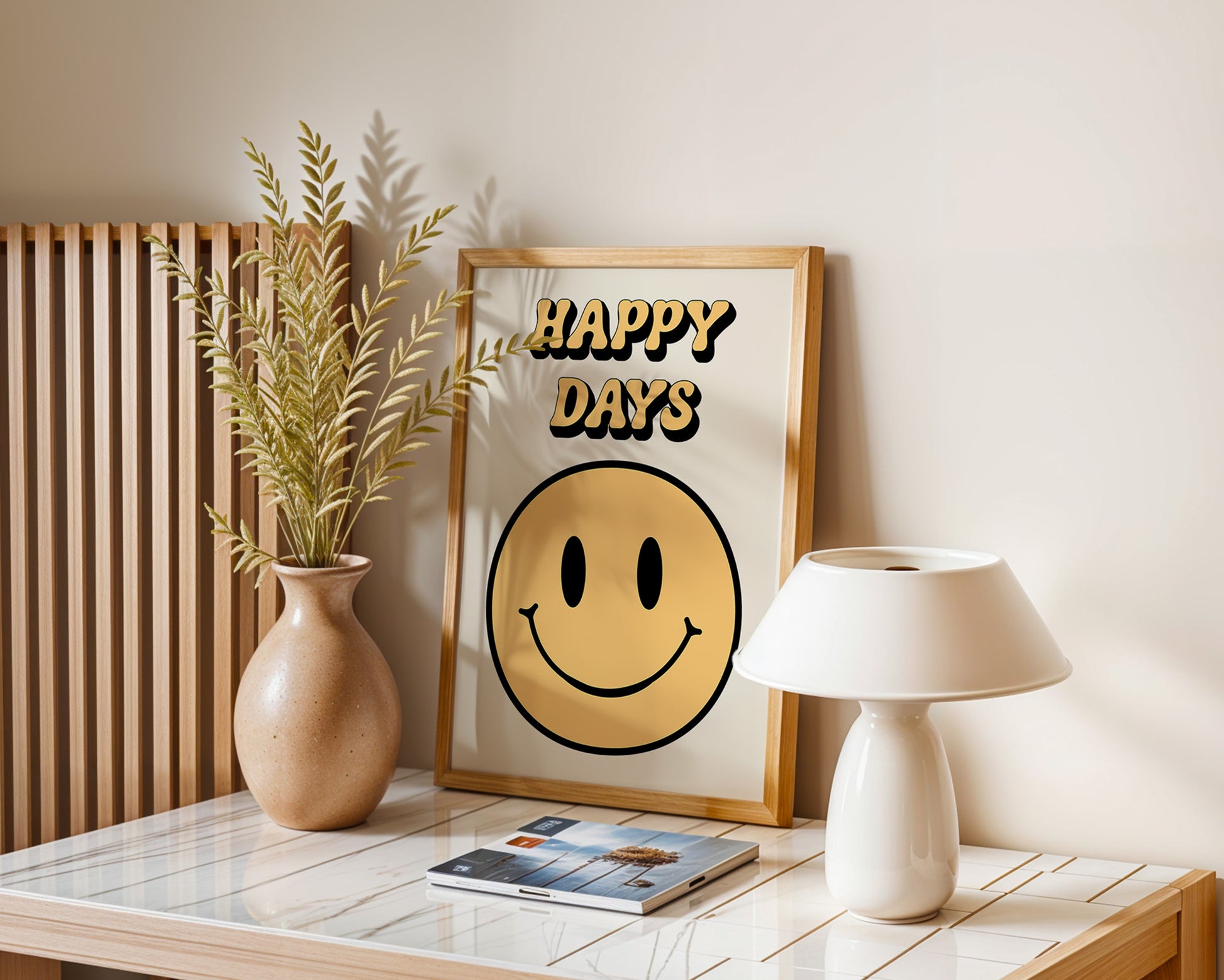 A series of 'Happy Days' retro art prints with various colored smiley faces displayed on a wall, below a window with natural light coming in and a plant to the side.