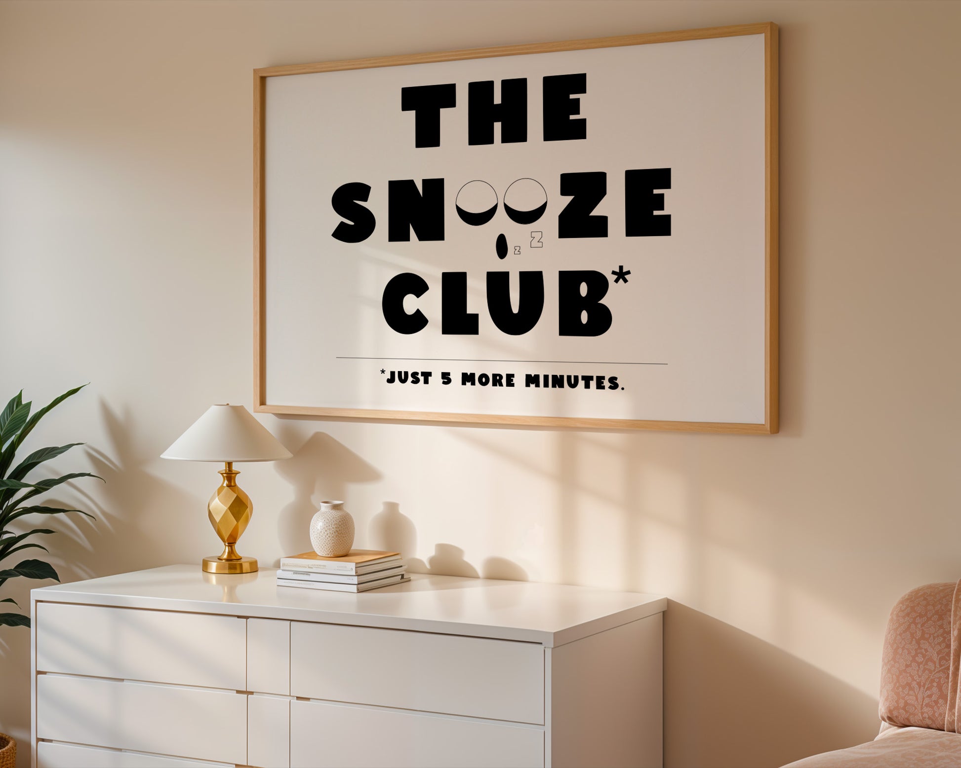 "Minimalist black and white wall art print with ‘The Snooze Club’ text, a perfect gift for heavy sleepers."